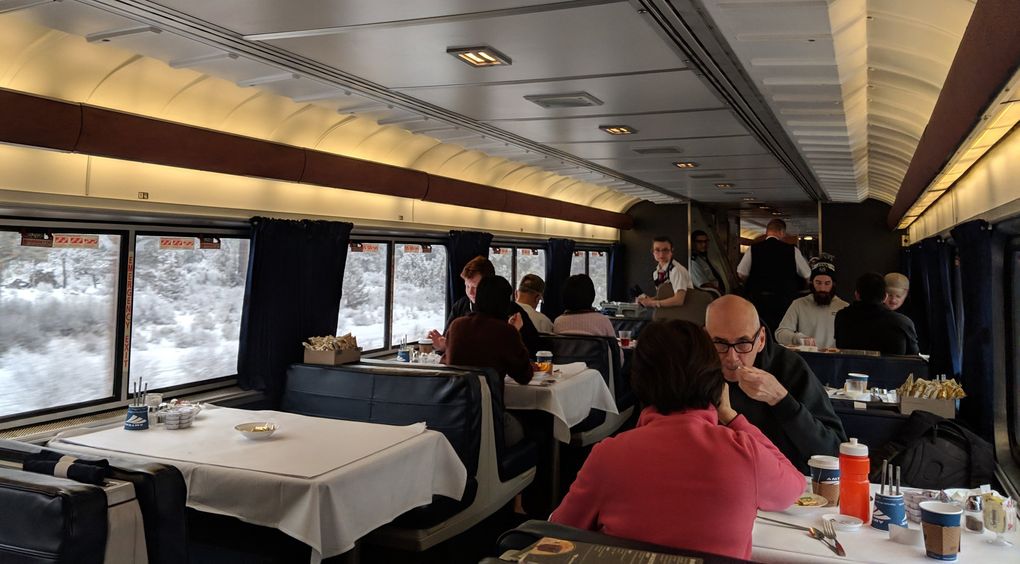 The dining-car experience can mean sharing a meal with new people or sitting in awkward silence with strangers. (Crystal Paul / The Seattle Times)