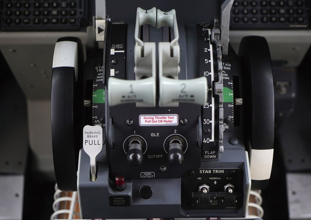 The center console between the captain and first officer in a MAX cockpit. The black wheels on either side are directly connected to the horizontal tail and will spin if it swivels. The two switches toward bottom right, labeled “STAB TRIM,” are the cutoff switches that will end any automated movement of the horizontal tail. (Dimas Ardian / Bloomberg)