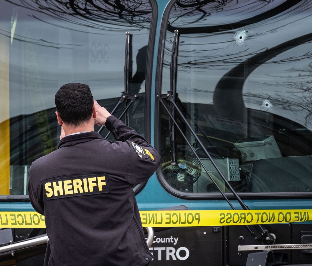 Bullet holes mar the windshield of a Metro bus on 125th Street Northeast in Seattle. (Dean Rutz / The Seattle Times)