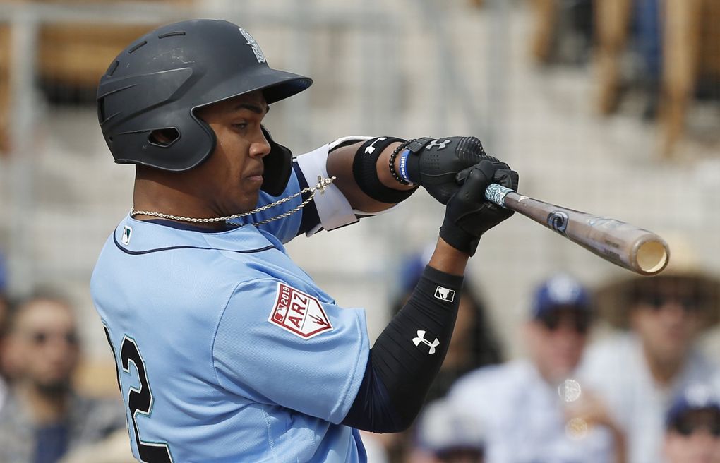Julio Rodriguez strikes out swinging March 9 in Phoenix. (Sue Ogrocki / The Associated Press)