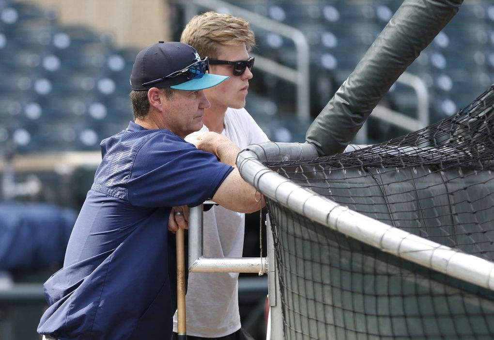 Sam Carlson, the Burnsville, Minn. right-handed high school pitcher drafted by the Seattle Mariners in the second round of the baseball draft, and Mariners manager Scott Servais, right, watch batting practice in Minnesota in 2017. (Jim Mone / The Associated Press)