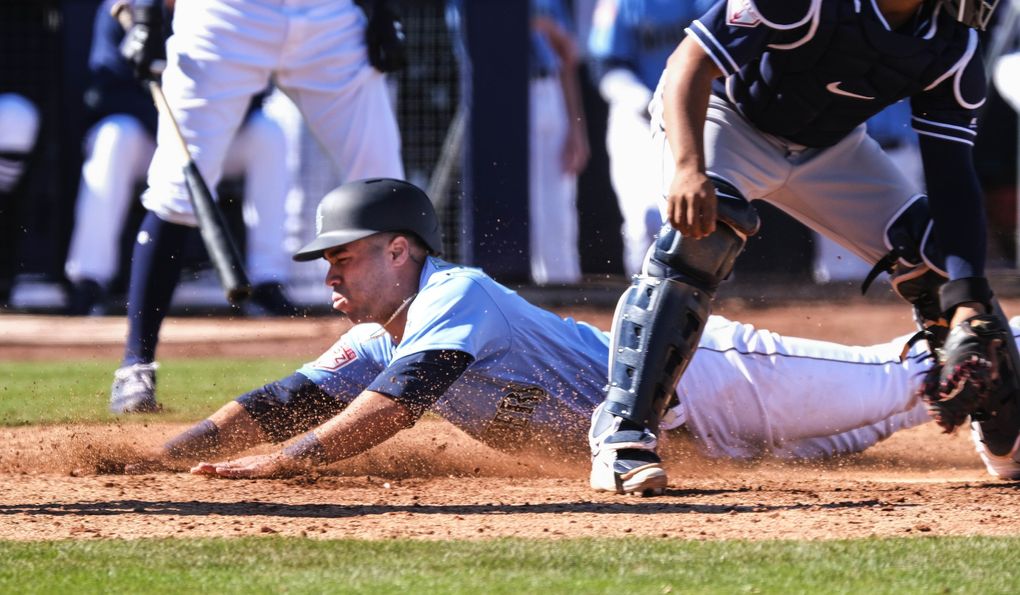 Dom Thompson-Williams scores from third in spring training Feb. 23 in Peoria, Arizona. (Dean Rutz / The Seattle Times)