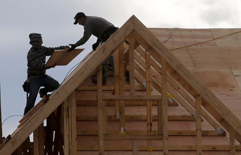 FILE – In this Feb. 26, 2018 file photo, construction workers work on a new townhouse in Wood-Ridge, N.J.  U.S. construction spending edged up in November as a gain in home building helped offset weakness in nonresidential construction. The Commerce Department said Friday, Feb. 1, 2019,  construction spending was up 0.8 percent in November after a 0.1 percent gain in October and a 1.8 percent fall in September. (AP Photo/Seth Wenig, File)