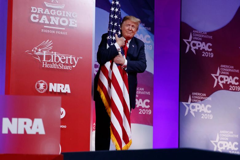 President Donald Trump hugs the American flag as he arrives to speak at Conservative Political Action Conference, CPAC 2019, in Oxon Hill, Md., Saturday, March 2, 2019. (AP Photo/Carolyn Kaster)