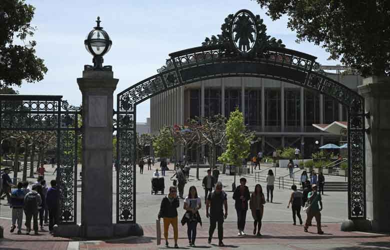 Students walk past Sather Gate on the University of California at Berkeley campus in Berkeley, California. Choosing a college based on price can save you from overwhelming student debt, give your parents a break and increase the likelihood of a return on investment in your education. (AP file photo by Ben Margot)