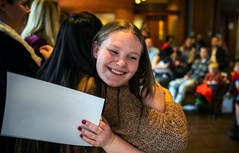Cicelia Bracken is congratulated after receiving her certificate after completing the Rising Strong drug rehab program in Spokane, Wash. Jan 25, 2019.   (Rajah Bose for The Seattle Times)