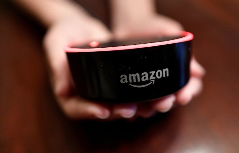 HFM JENNY KAN**A child holds his Amazon Echo Dot, Thursday, Aug. 16, 2018, in Kennesaw, Ga. (AP Photo/Mike Stewart)