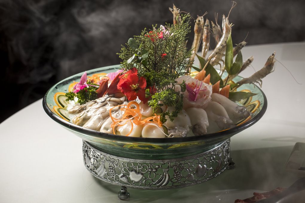 The seafood platter at Liuyishou Hotpot in Bellevue is one of the popular dishes that fans order to dunk the medley of shellfish and fillets into the spicy broth. (Bettina Hansen / The Seattle Times)