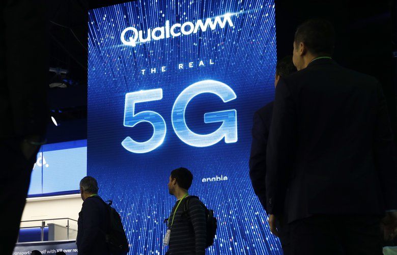 FILE- In this Jan. 9, 2019, file photo a sign advertises 5G at the Qualcomm booth at CES International in Las Vegas. Apple and mobile chip maker Qualcomm have settled a bitter financial dispute centered on some of the technology that enables iPhones to connect to the internet. The surprise truce announced Tuesday, April 16, came just as the former allies turned antagonists were facing off in a federal court trial that was supposed to unfold over the next month in San Diego. The resolution abruptly ended that trial. (AP Photo/John Locher, File) NYBZ262 NYBZ262