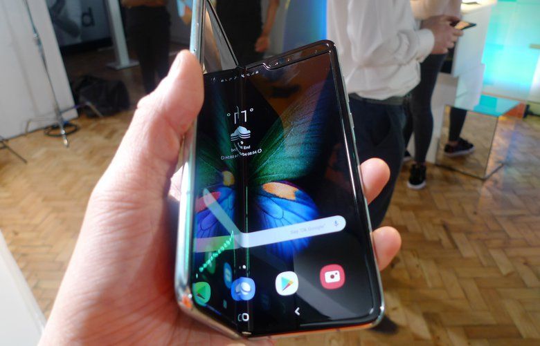 The Samsung Galaxy Fold smartphone is seen during a media preview event in London, Tuesday April 16, 2019.  Samsung is hoping the innovation of smartphones with folding screens reinvigorates the market. (AP Photo/Kelvin Chan)