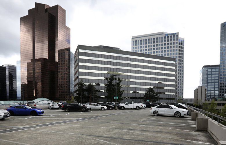 The 600 108th Ave. NE building in Bellevue, center, has been purchased by Amazon, as well as the adjacent parking structure to its east, foreground, Tuesday, April 23, 2019. 210027 210027