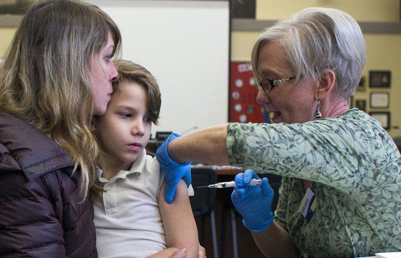 FILE — Heidi Clarke holds her son Micah Risner as a nurse administers an immunization in Portland, Ore., Feb. 16, 2019. The number of measles cases has now surpassed 700 in the United States this year, and the virus has been found in 22 states, federal officials said. More than 500 of the 704 cases were in people who had not been vaccinated. (Alisha Jucevic/The New York Times) XNYT59 XNYT59