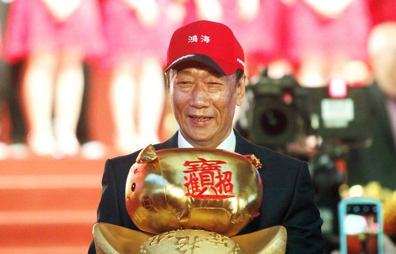 FILE – Terry Gou, chairman of Hon Hai Precision Industry Co. Ltd., also known as Foxconn, holds New Year’s lucky charm during the company’s annual carnival for employees in Taipei, Taiwan. Gou, head of Foxconn, worldâ€™s largest electronics supplier, says Wednesday, April 17, 2019, willing to run in Taiwan presidential primary. (AP Photo/Chiang Ying-ying, File) TKTT102 TKTT102