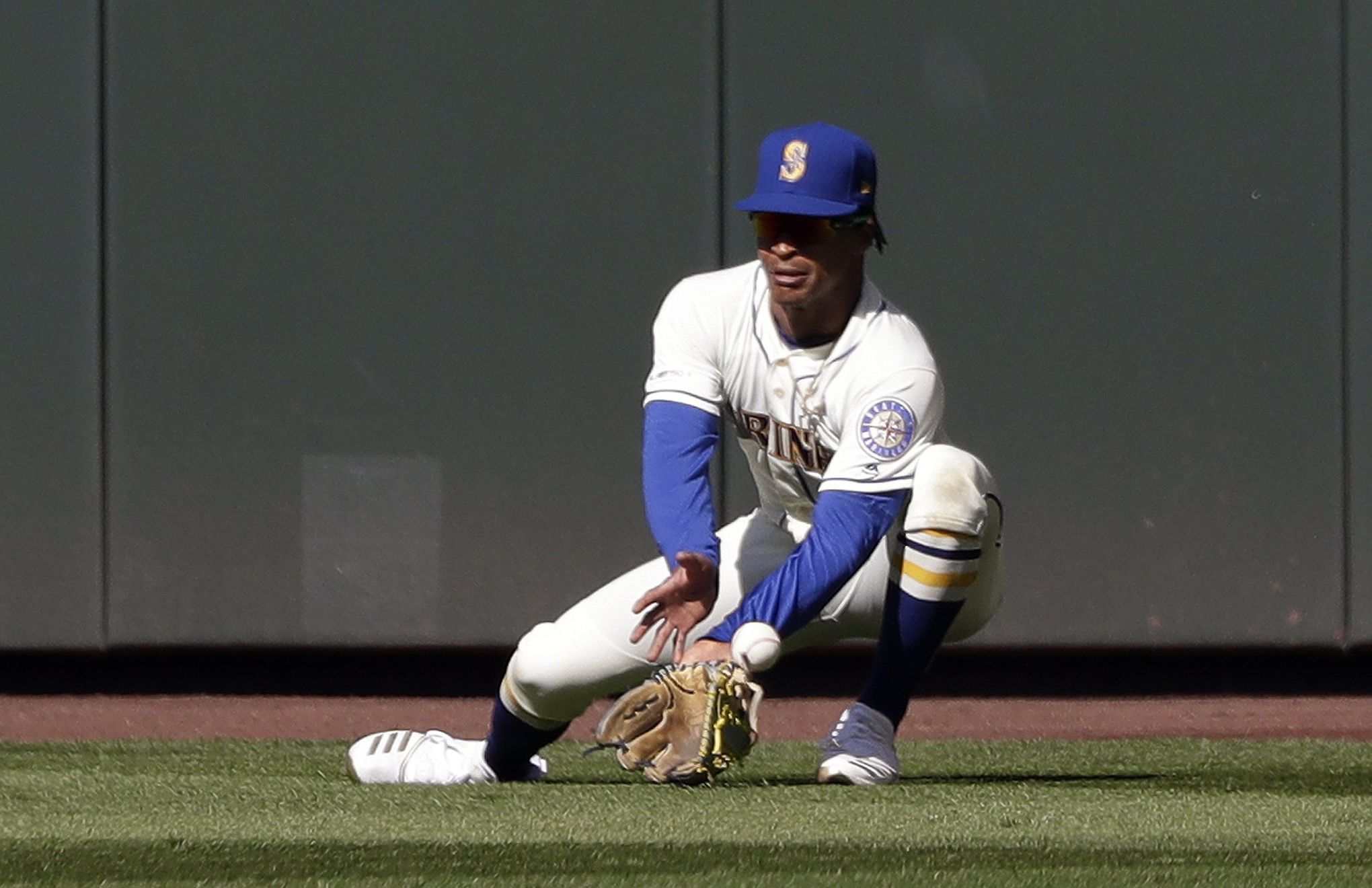 Seattle Mariners first baseman Dae-Ho Lee reacts after a ball hit