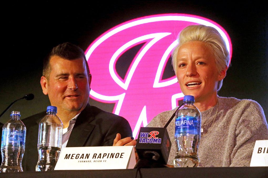 At Tacoma’s Cheney Stadium, Bill Predmore, left, the owner of the women’s professional soccer team, Reign FC, announced that the team is moving to Tacoma.
Speaking at right is Megan Rapinoe, Reign FC forward. They plan to play at the Cheney baseball stadium, with plans to build their own stadium in Tacoma. (Greg Gilbert / The Seattle Times)