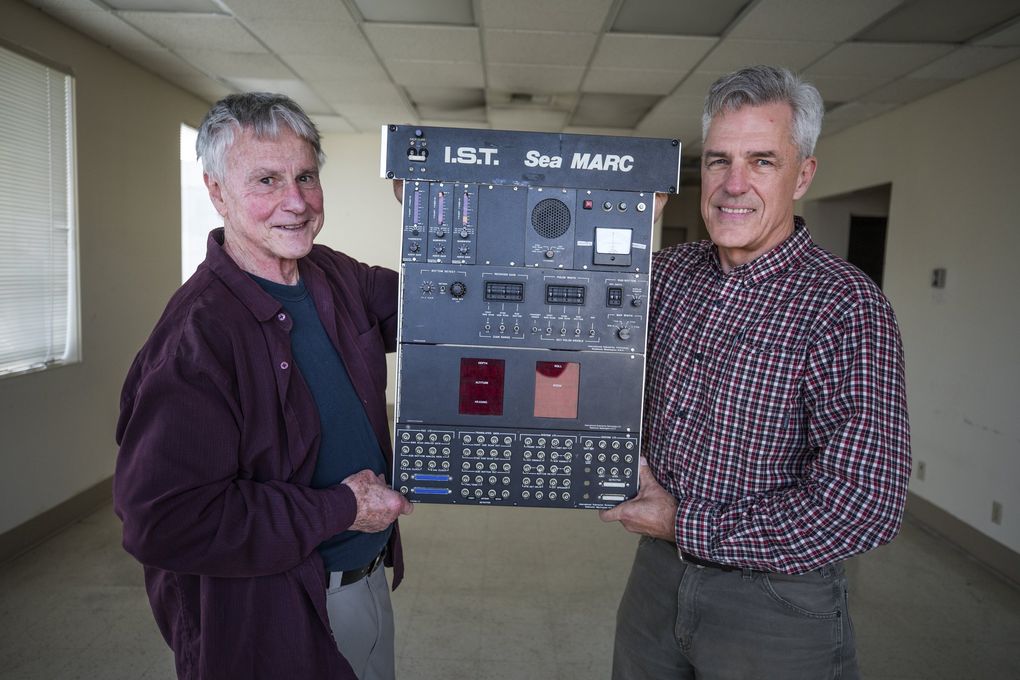 Mike Williamson, left, and Tim McGinnis hold the control panel that McGinnis, an ocean engineer, built part of the specialized sonar that eventually found the sunken SS Central America. (Steve Ringman / The Seattle Times)