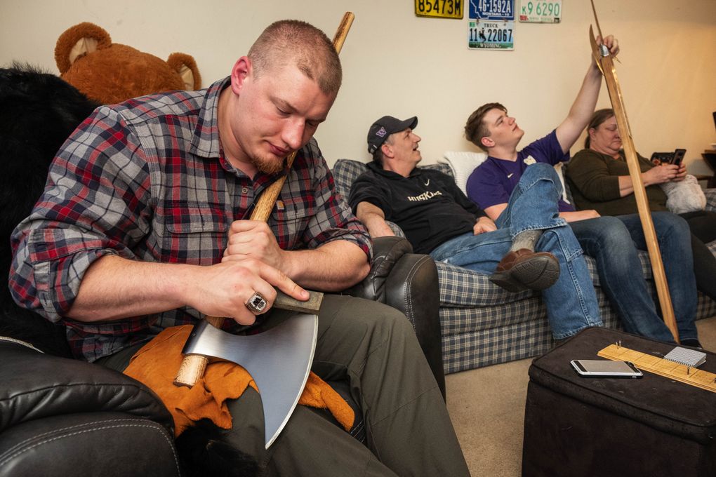 Kaleb McGary, a fan of medieval times, polishes one of several such period-type tools he’s collected. The Atlanta Falcons moved up to take Washington’s McGary in the first round of the NFL draft Thursday. (Dean Rutz / The Seattle Times)