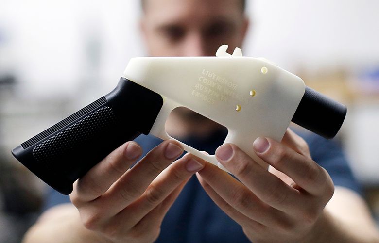 Cody Wilson, with Defense Distributed, holds a 3D-printed gun called the Liberator at his shop, Wednesday, Aug. 1, 2018, in Austin, Texas. A federal judge in Seattle has issued a temporary restraining order to stop the release of blueprints to make untraceable and undetectable 3D-printed plastic guns. (AP Photo/Eric Gay)