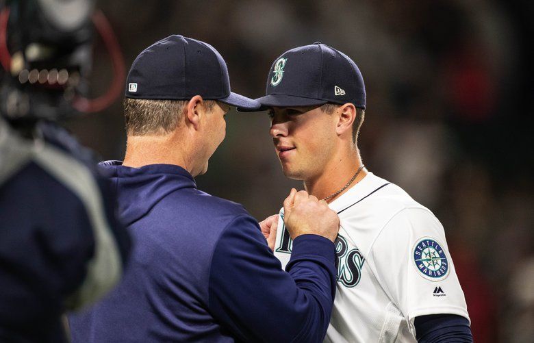 Seattle Mariners' Dee Gordon celebrates in the dugout after a home