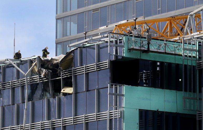 Investigators at the scene of a collapsed crane at the corner of Fairview and Mercer killing four on Saturday April 27, 2019 210077 210077
