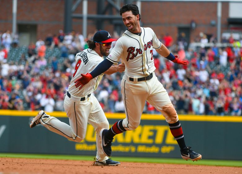 The Braves' Dansby Swanson high fives teammates prior to a game