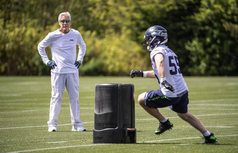 Seattle Seahawks wide receivers John Ursua (15) and Gary Jennings (11)  watch drills on the first