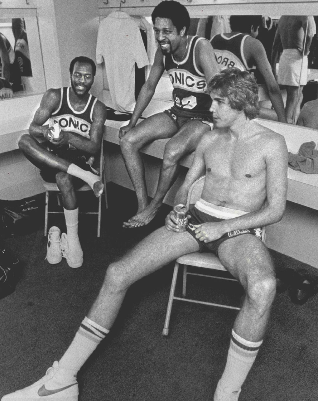 The Seattle locker room was a sea of smiles after the Sonics shaded the Phoenix Suns to keep their title hopes alive. From left: Gus Williams, Fred Brown and Wally Walker. (Matt McVay / The Seattle Times)