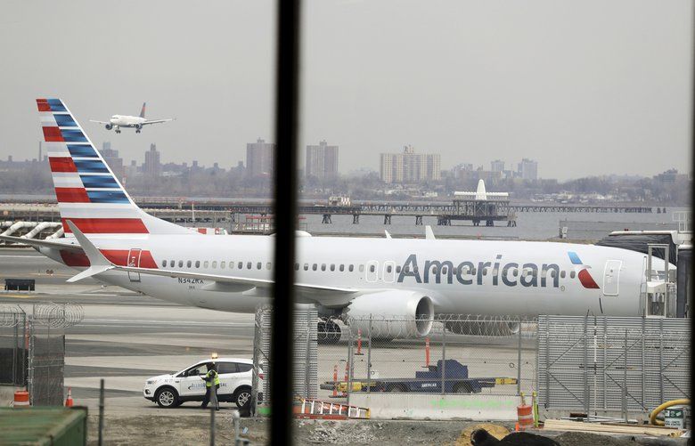 FILE – In a March 13, 2019 file photo, an American Airlines Boeing 737 MAX 8 sits at a boarding gate at LaGuardia Airport in New York. American Airlines expects to take a $1 billion hit from two things it didn’t expect when 2019 started: That its newest Boeing jet would be grounded for months after two deadly crashes, and that oil prices would rise. (AP Photo/Frank Franklin II, File) NYBZ506 NYBZ506