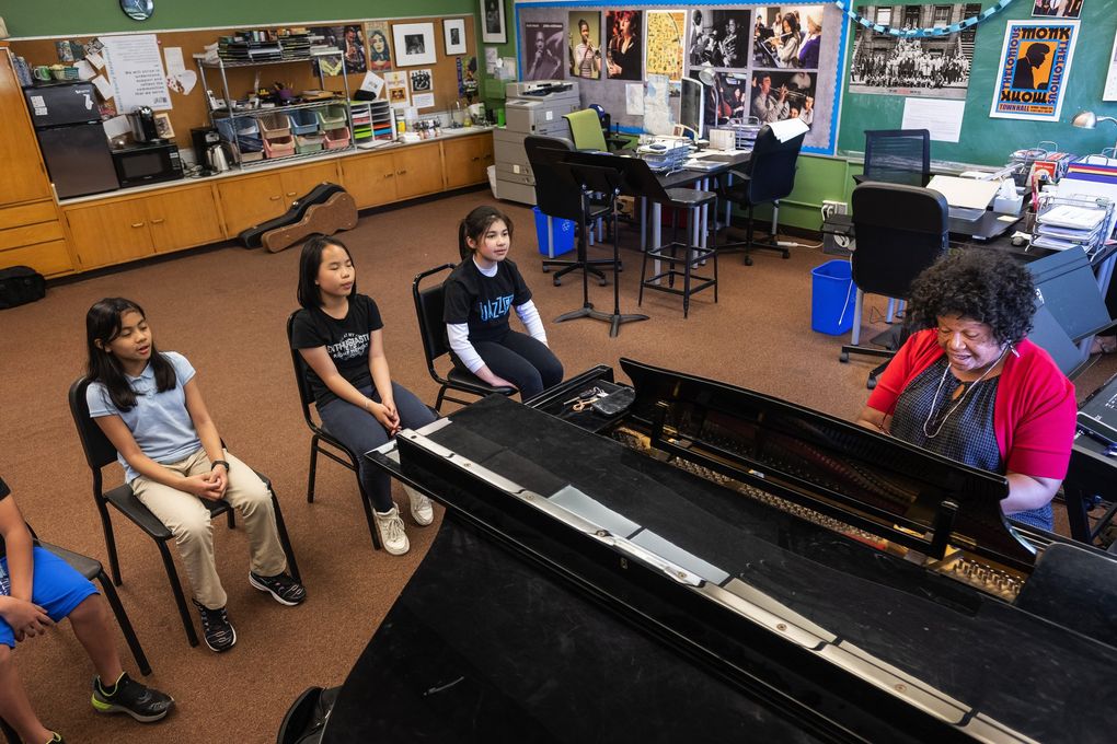 From left, Aaliyah Tab, Zi Chen and Cynthia Brunk take beginning vocals from gospel singer Cora Jackson at JazzED. (Dean Rutz / The Seattle Times)