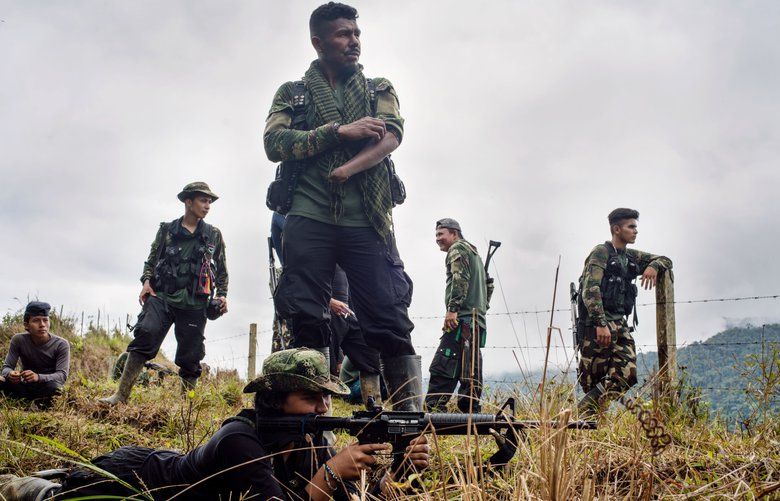 FILE — A new rebel with the Revolutionary Armed Forces of Colombia, known as the FARC, learns the ropes from a veteran during training in the mountains north of Medellin, Colombia, on Aug. 31, 2018. Rebels are rearming, violence is soaring in the countryside and the new government is wavering in its commitment to the peace deal reached in September 2016. (Federico Rios Escobar/The New York Times) XNYT42 XNYT42