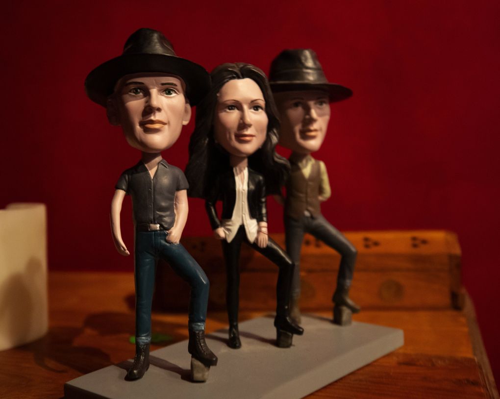 Bobbleheads of Tim and Phil Hanseroth and Brandi Carlile sit on a dresser in the band’s Maple Valley studio. (Ellen M. Banner / The Seattle Times)
