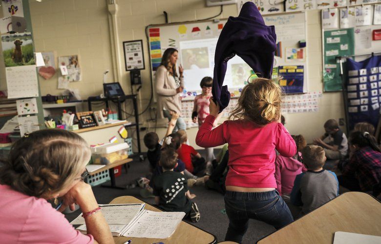 A young student unable to contain her energy is kept in the back of the classroom so as not to disturb the class at Woodlawn Heights Elementary in Laconia, N.H. Monday, May 6, 2019.