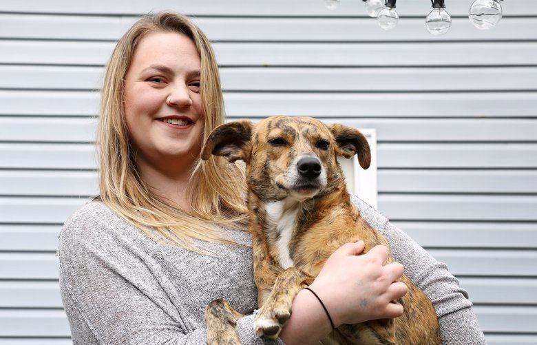 Lindsey Norden, who is the subject of a Money Makeover, at home with her dog Charlie, Tuesday, May 28, 2019 in Seattle. 