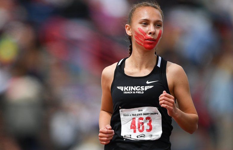Rosalie Fish (463) of Muckleshoot Tribal competes in the 1B Girls 3200m during the Washington State Track and Field Championships on Saturday, May 25, 2019, in Cheney, Wash. Fish painted her face with a hand print to raise awareness for Missing and Murdered Indigenous Women. Tyler Tjomsland/THE SPOKESMAN-REVIEW SR1905251551003053