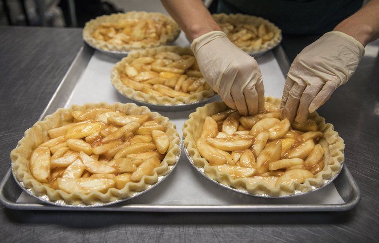 Tuesday, May 21, 2019.    Pie maker Hannah Jacobsen spreading out the apple filling for pie’s that will be sold at farmers markets and a pie club.  Her company in Seattle is called Pie Bird Bakeshop.   210235
