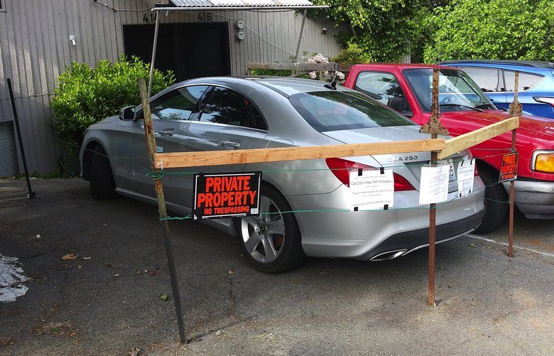 Dan Smith, a property owner on Queen Anne, says this Car2Go was illegally parked on his property. After the company failed to retrieve the vehicle he set up a barricade around it.