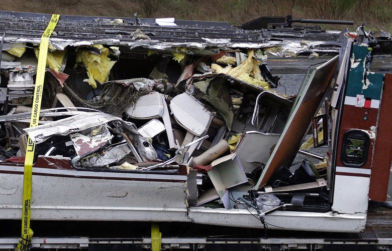 Seats are jammed together with other debris on an upside-down Amtrak train car taken from the scene of Monday’s deadly crash onto Interstate 5  Tuesday, Dec. 19, 2017, in DuPont, Wash. The Amtrak train that plunged off an overpass south of Seattle was hurtling 50 mph over the speed limit when it jumped the track, federal investigators said. (AP Photo/Elaine Thompson) WAET112 WAET112 WAET112