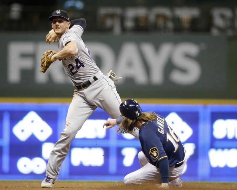 Raimel Tapia of the Colorado Rockies throws the ball in from right