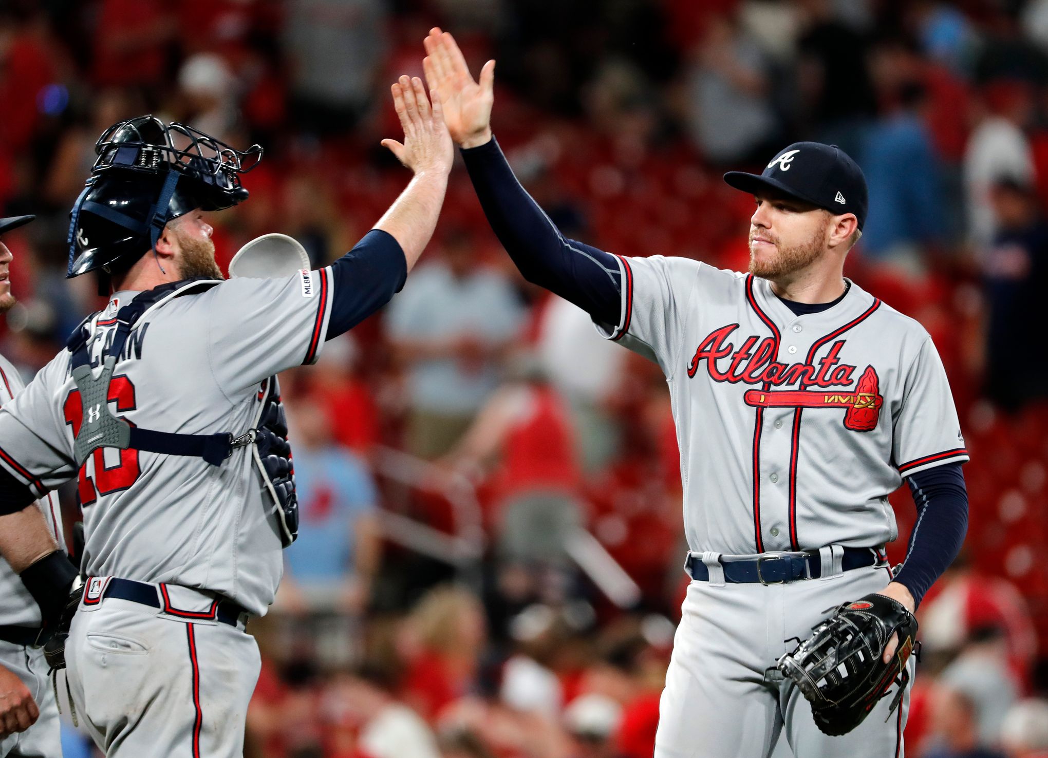 Atlanta Braves - Brian McCann celebrates in the dugout after his