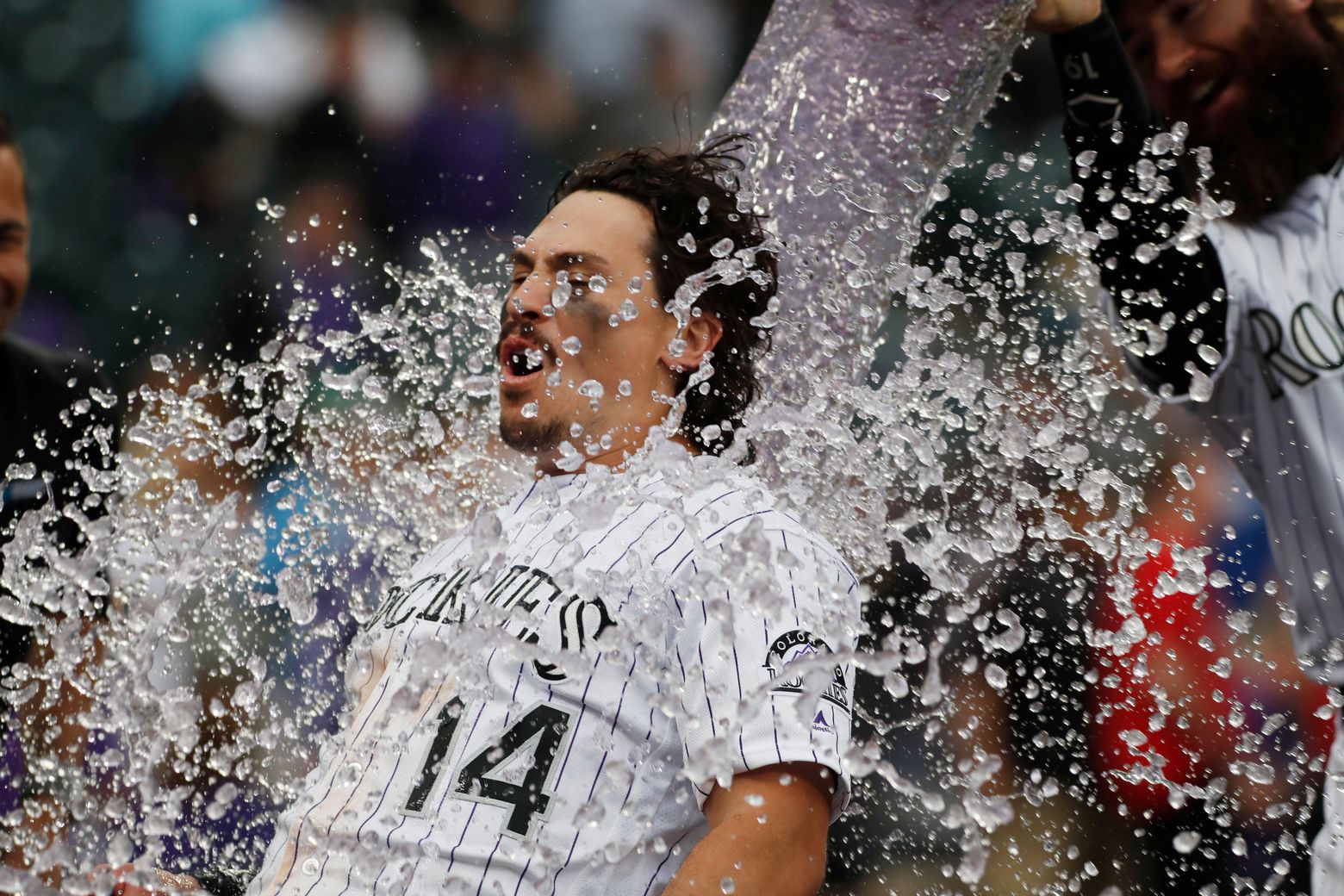 Colorado Rockies Tony Wolters (14) scores on RBI-double hit by