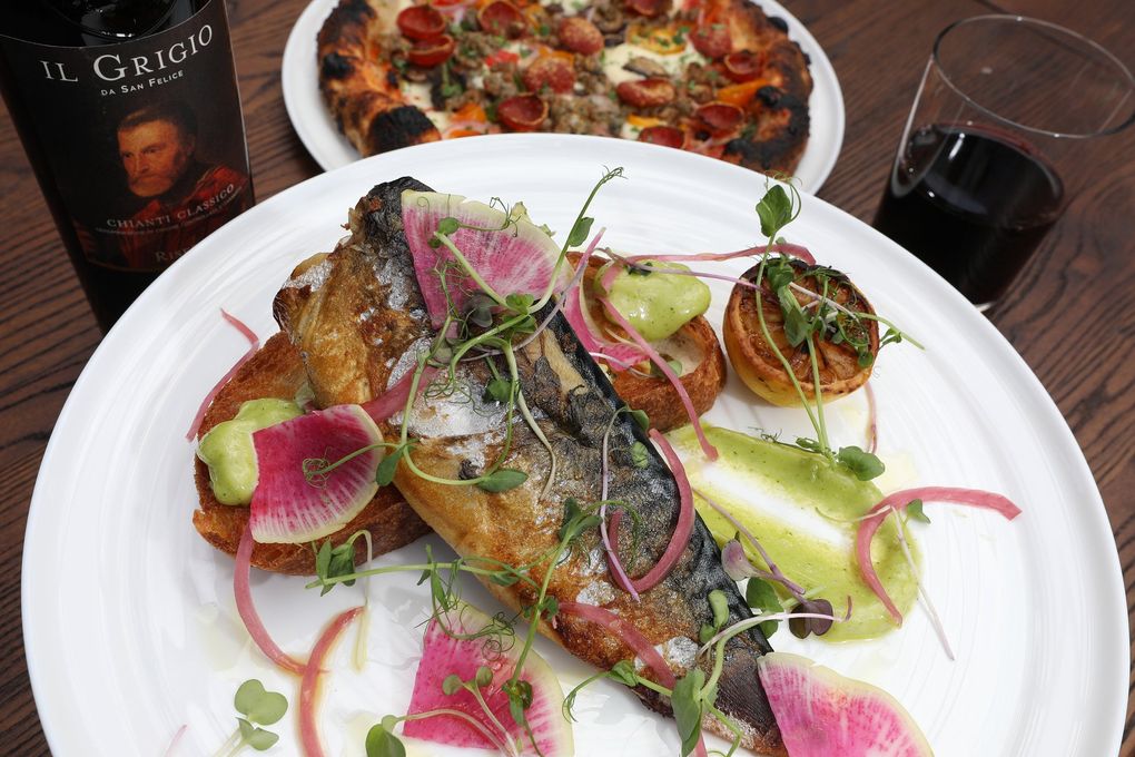 Spark’s “Holy Mackerel Bruschetta,” foreground, the “Homage to Frankie’s” pizza and a glass of Il Grigio Chianti Classico. (Greg Gilbert / The Seattle Times)