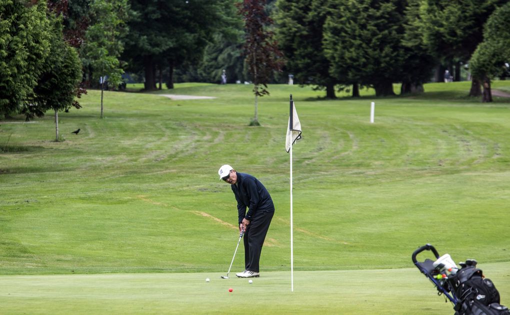 A golfer putts on the second green at Jefferson Golf Course in Seattle on Wednesday. (Steve Ringman / The Seattle Times)
