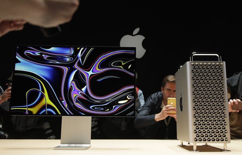 People take pictures of the Mac Pro in the display room at the Apple Worldwide Developers Conference in San Jose, Calif., Monday, June 3, 2019. (AP Photo/Jeff Chiu) CAJC CAJC