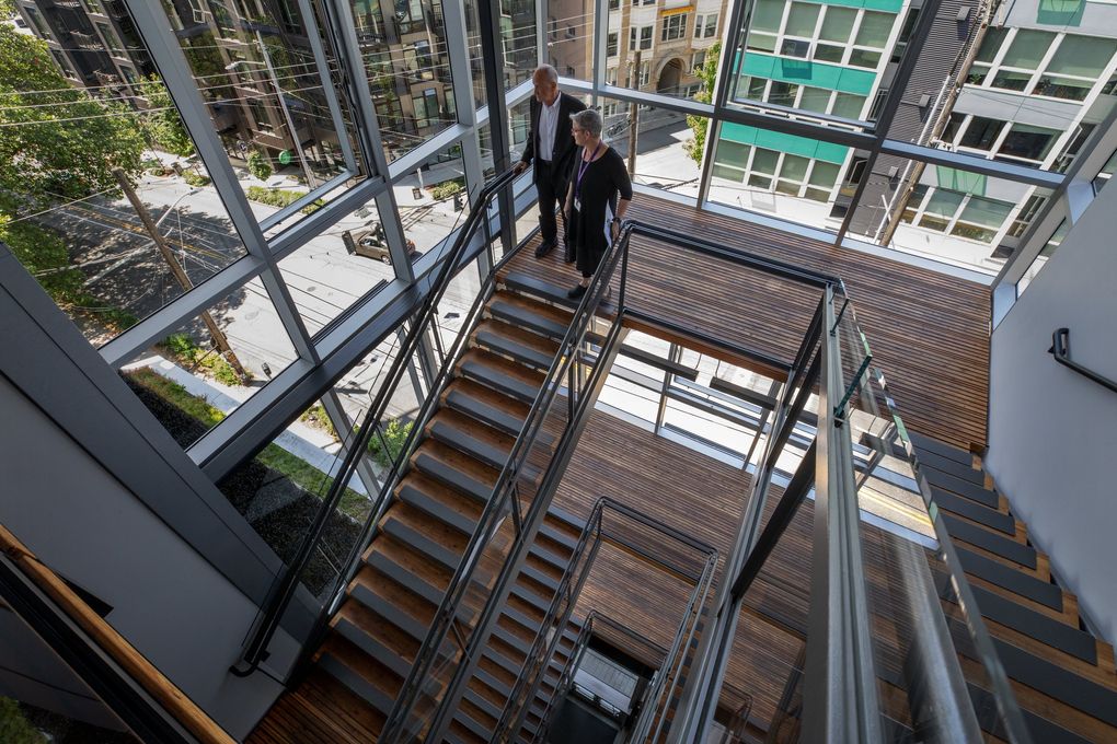 Denis Hayes, president and CEO of The Bullitt Foundation in Seattle, and Deborah Sigler, program coordinator of Discovery Commons, Center for Integrated Design, take a stroll downstairs in the Bullitt Center. (Ellen M. Banner / The Seattle Times)