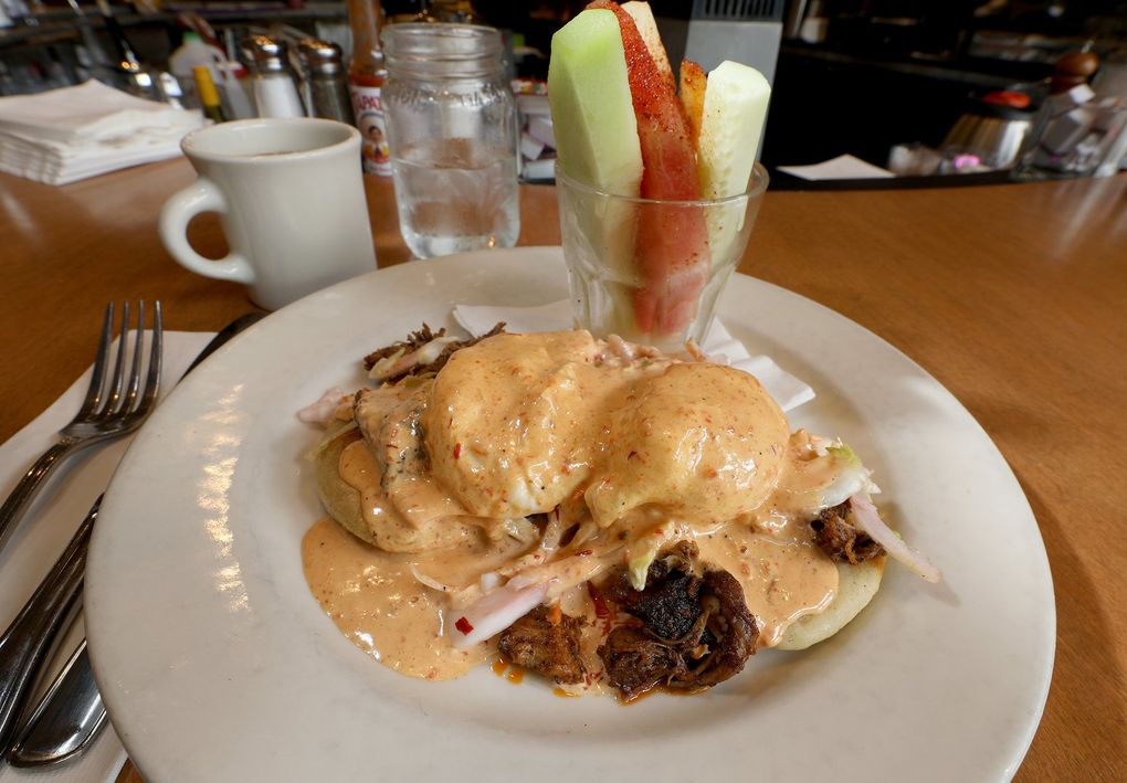Pupusas are the cheese-filled heart of the menu’s enormous, gloriously messy El Benedicto Salvadoreño. (Greg Gilbert / The Seattle Times)