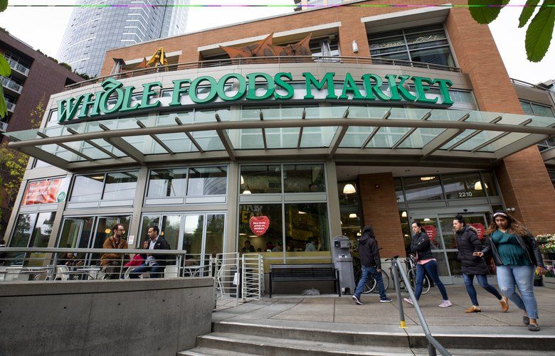 Customers and others walk past Whole Foods Market at the corner of  Denny Way and Westlake Ave. in Seattle Thursday, April 18, 2019.  

Amazon-owned Whole Foods touted a price cut on halibut as part of an announcement recently about lower prices on hundreds of items. Amazon is trying to shed the Whole Paycheck image of the grocery chain, which has been a leader in sustainable seafood practices. Wade Bassi, of Seattle, fishes for halibut in Alaska all summer and says the halibut price advertised, about $17 a pound for fillets, is almost certainly a loss leader, meaning there’s little or no room for the retailer to profit, based on what he knows about the supply chain.  209887