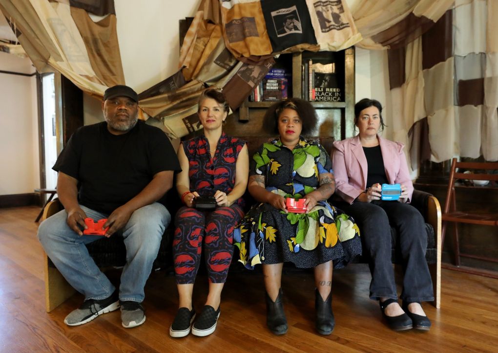 The co-founders of Wa Na Wari, a new community center for black art, storytelling and gathering, are Inye Wokoma, left, Rachel Kessler, Elisheba Johnson and Jill Freidberg. The fabric art piece above them, which winds through the main floor, is by Melanie Stevens. (Alan Berner / The Seattle Times)