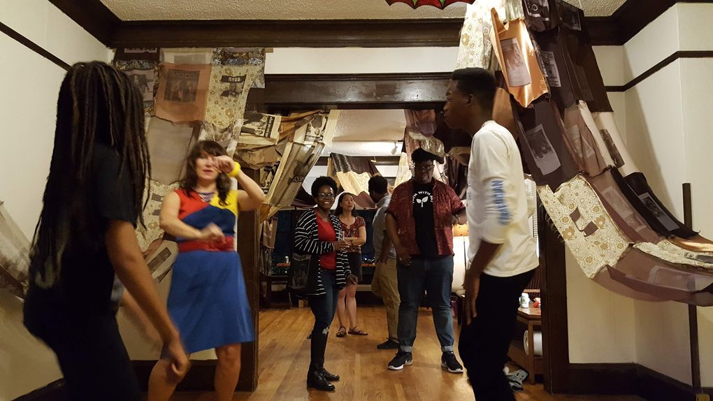 Visitors to Wa Na Wari party beneath artwork by Portland-based artist Melanie Stevens, whose fabric installation weaves through the main floor. (Courtesy of Wa Na Wari)