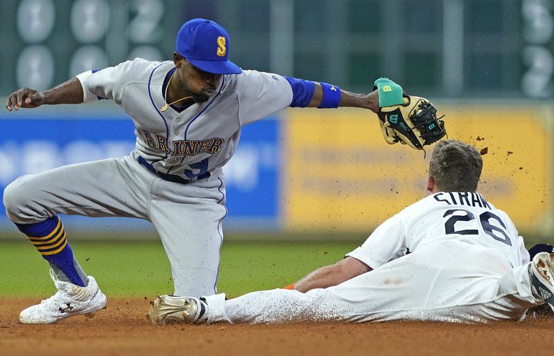 Houston Astros’ Myles Straw (26) steals second base as Seattle Mariners’ Dee Gordon (9) reaches to tag him during the seventh inning of a baseball game Friday, June 28, 2019, in Houston. (AP Photo/David J. Phillip) TXDP116 TXDP116