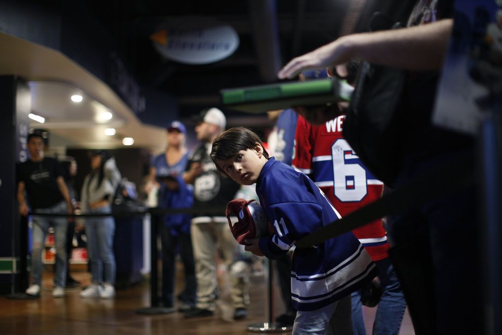 Dominic Clark, 7, waits for draft picks to autograph his cap during the second day of the NHL draft last weekend at Rogers Arena in Vancouver, British Columbia. (Chad Hipolito/The Canadian Press via AP)